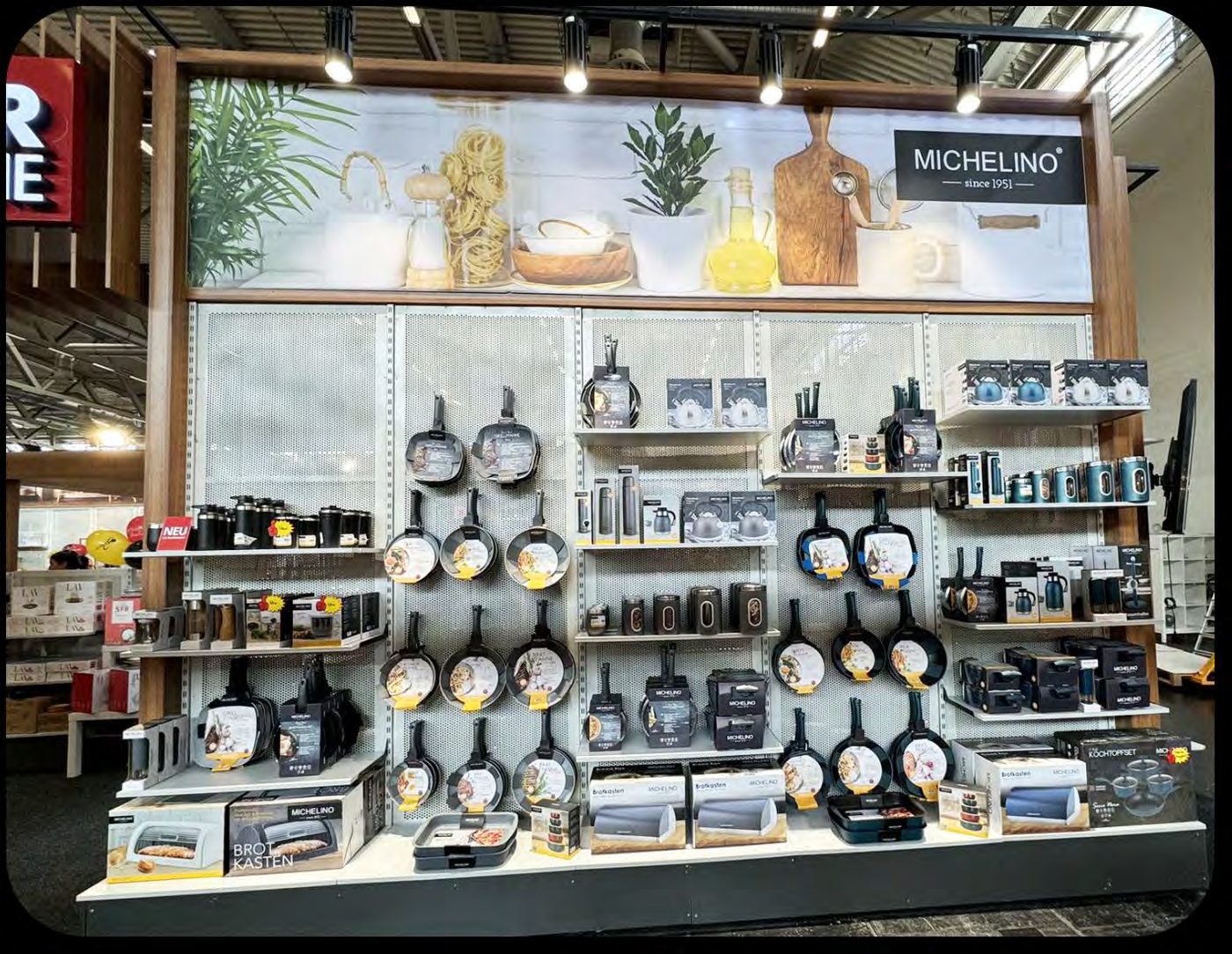 MICHELINO cookware and kitchen tools on a trade fair display wall
